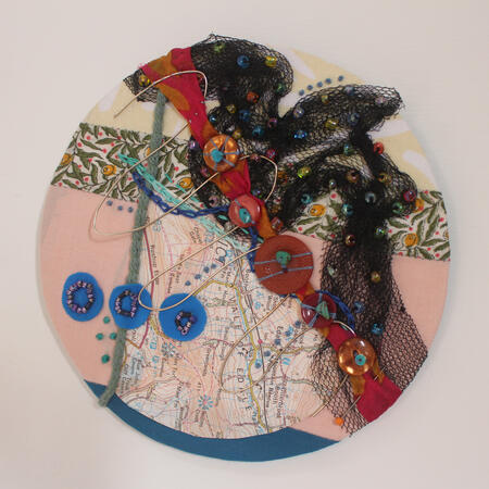 Circle abstract embroidery piece Bird Flight. Mostly Pink and Black with blue and orange accents