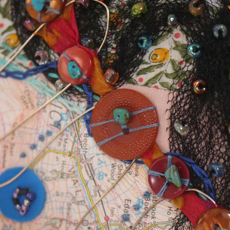 Circle abstract embroidery piece Bird Flight. Mostly Pink and Black with blue and orange accents