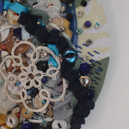 Circle abstract embroidery piece Moonlight. Made with many buttons and net. A huge mix of colours.